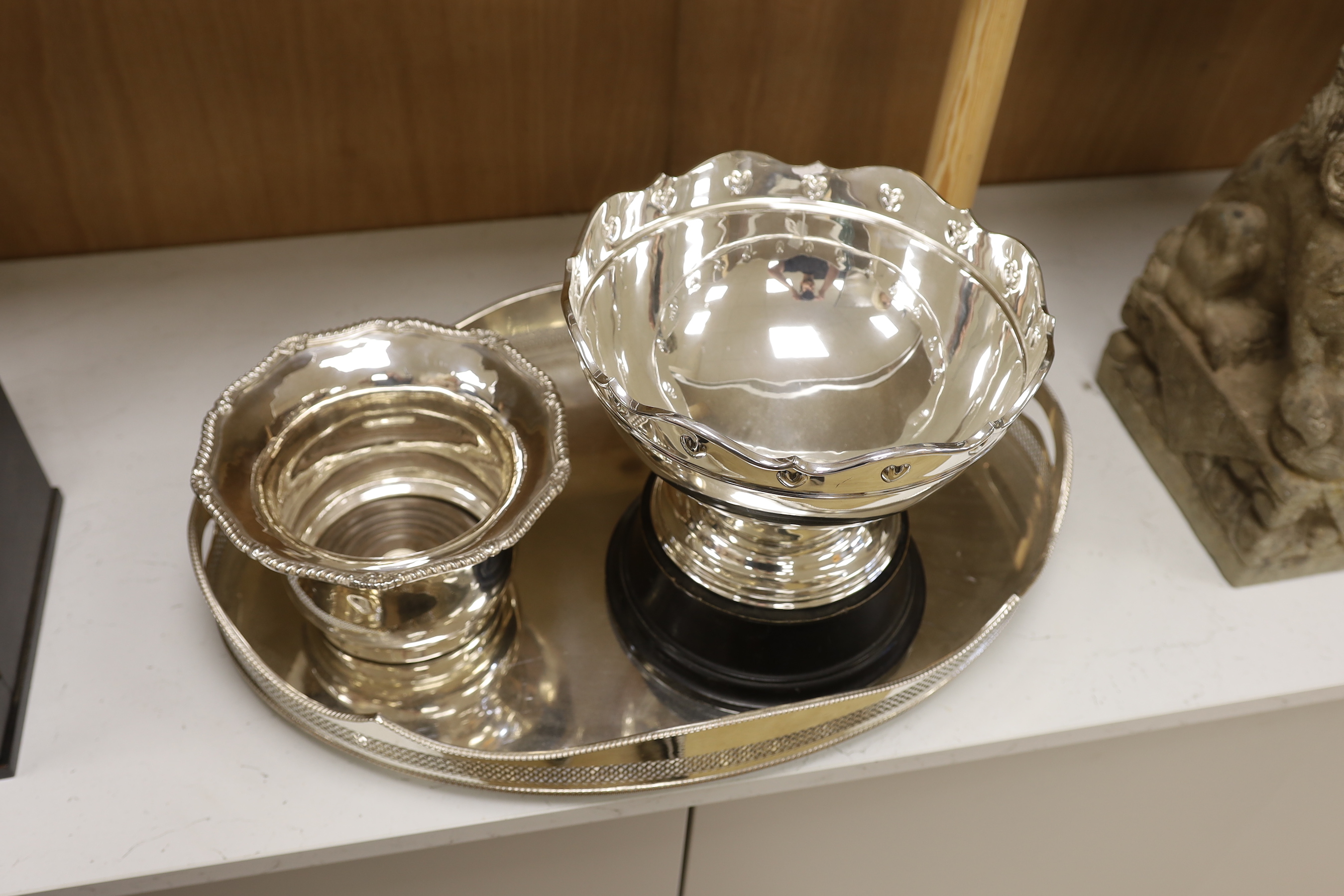 A plated galleried oval tray, an Arts & Crafts style punch bowl and bottle coaster, tray 60cm wide